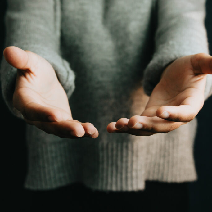 Woman giving hands to the camera, help and self help concept, mental health